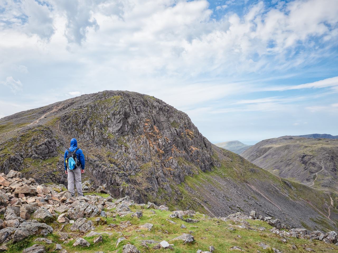 Travel photography England: A walker looks ahead to the mountain summit of Great Gable from Windy Gap in the Lake District, Cumbria, England.