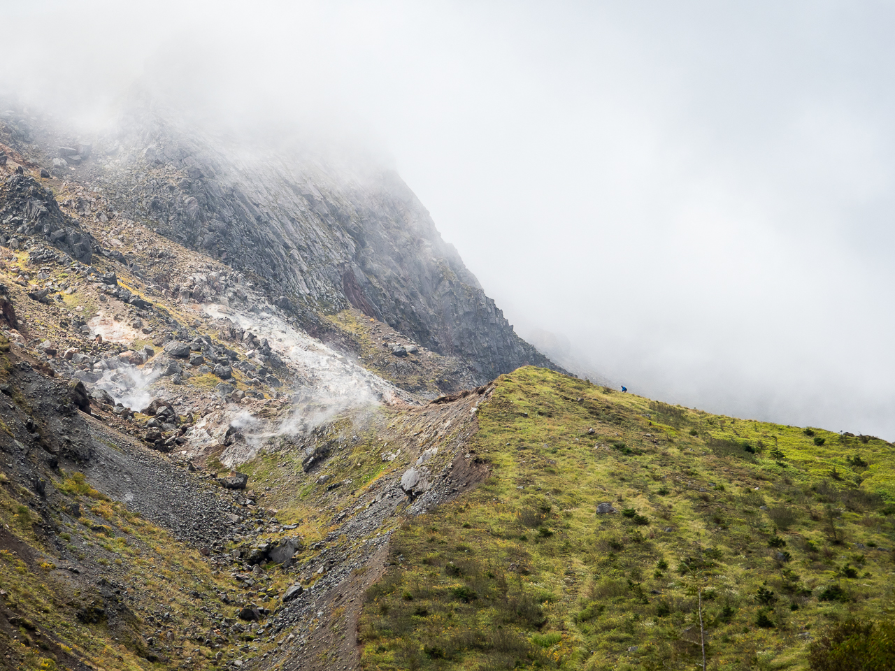 Walker near the summit of Mount Yake, a volcano in Kamikōchi (the Upper Highlands) in the Hida Mountains, Nagano Prefecture, Japan.